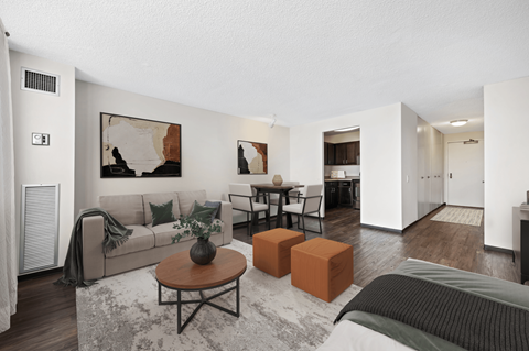 the living room of an apartment with a couch and a table at Presidential Towers, Chicago